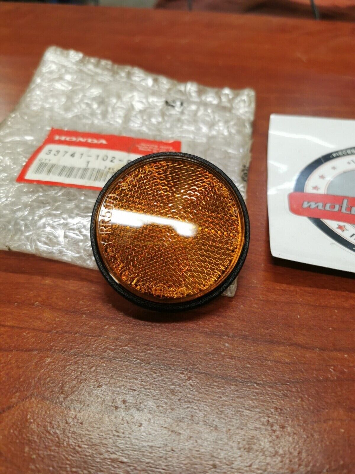 NOS Honda CMX250C CMX250X NH80 NQ50 FRONT REFLEX REFLECTOR 33741-102-870 H64