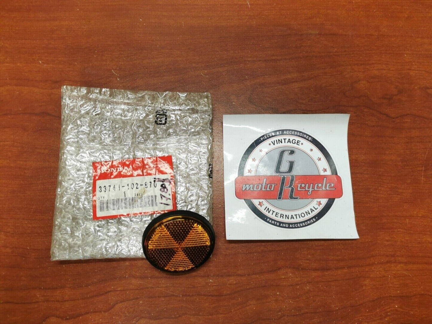 NOS Honda CMX250C CMX250X NH80 NQ50 FRONT REFLEX REFLECTOR 33741-102-870 H64