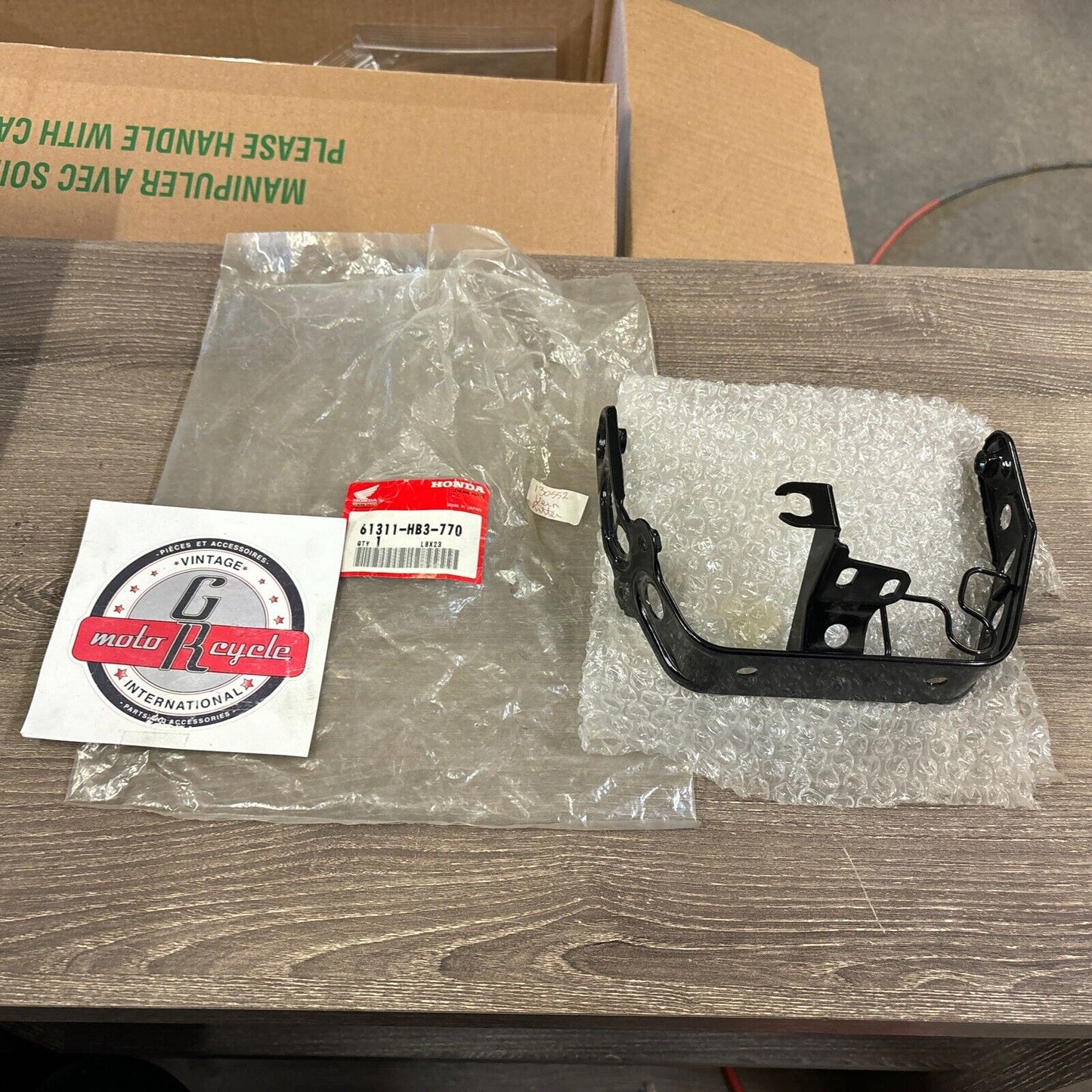 NOS Honda 1986 - 1987 TRX200SX HEADLIGHT BRACKET 61311-HB3-770 H114
