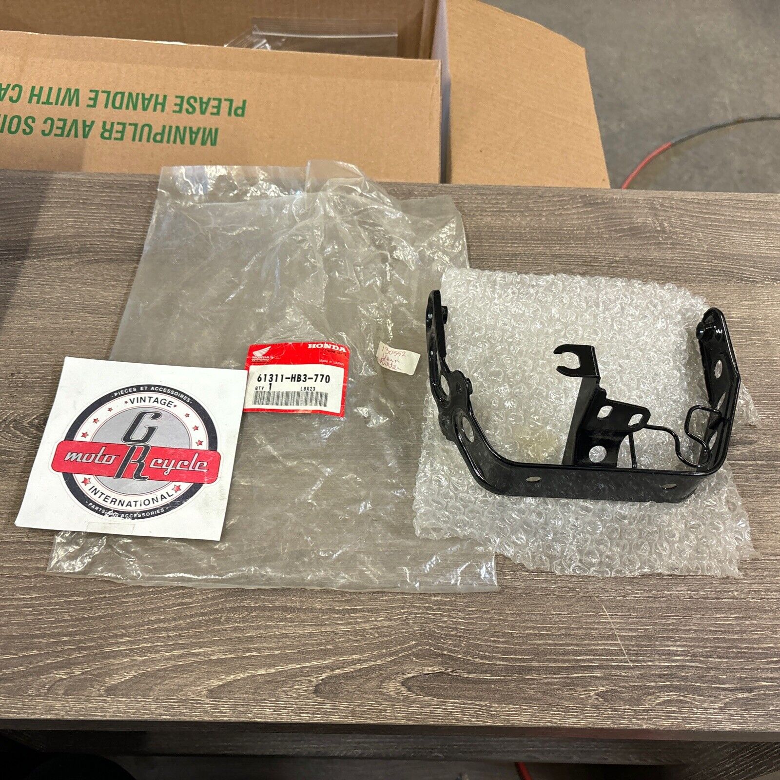 NOS Honda 1986 - 1987 TRX200SX HEADLIGHT BRACKET 61311-HB3-770 H114
