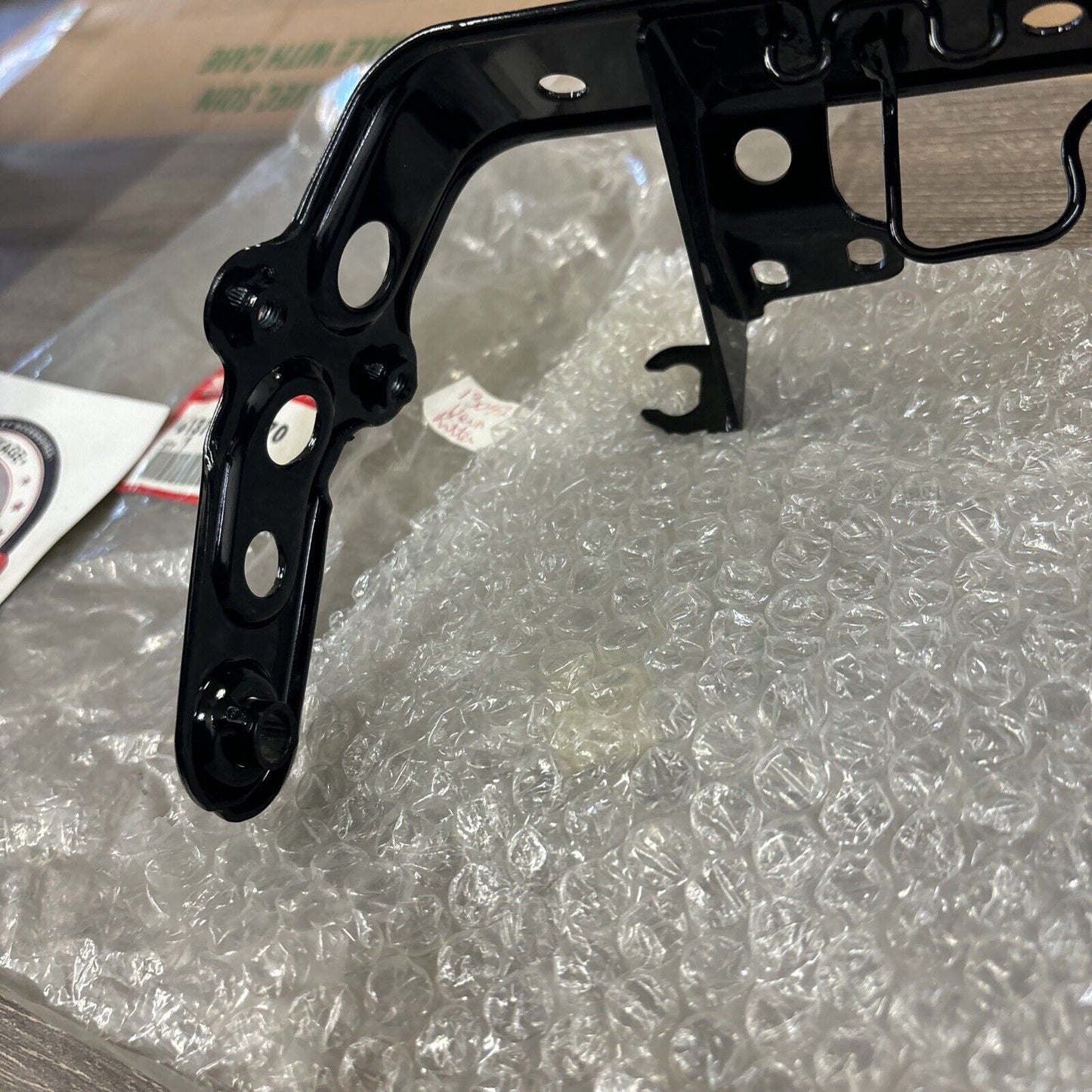 NOS Honda 1986 - 1987 TRX200SX HEADLIGHT BRACKET 61311-HB3-770 H114