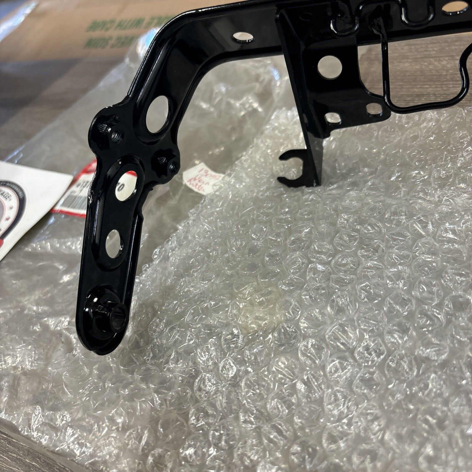 NOS Honda 1986 - 1987 TRX200SX HEADLIGHT BRACKET 61311-HB3-770 H114