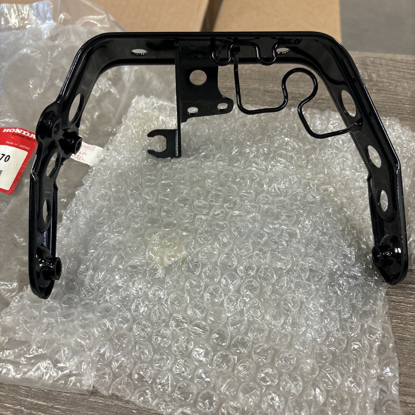 NOS Honda 1986 - 1987 TRX200SX HEADLIGHT BRACKET 61311-HB3-770 H114